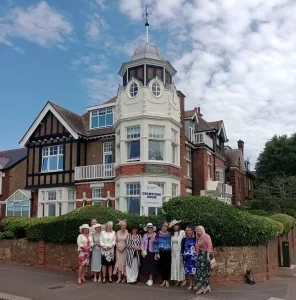ladies day standing by crowstone sign scaled e1720776587621